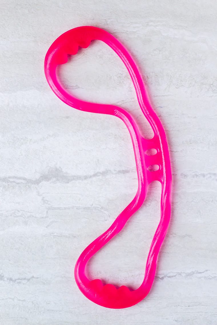 Hot pink resistance band on a white background
