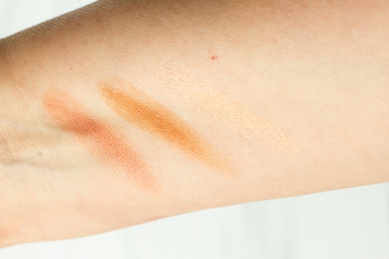 Laura Geller multi-tasking cream to powder trio swatched onto a arm