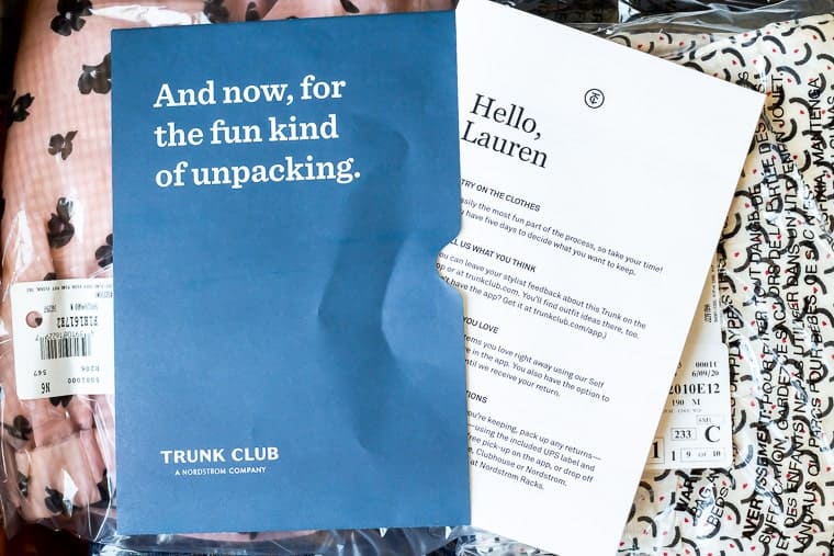 Opened trunk club box with letter and invoice on top of the items