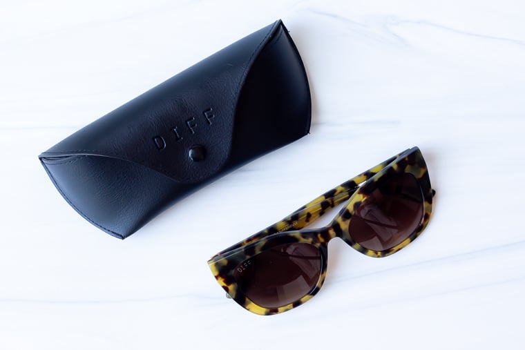 Diff Georgia 54mm Cat Eye sunglasses and case on a white background