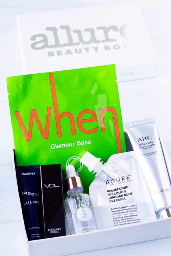 May 2020 Allure Beauty Box and all its contents displayed inside the box with the lid behind it on a white background