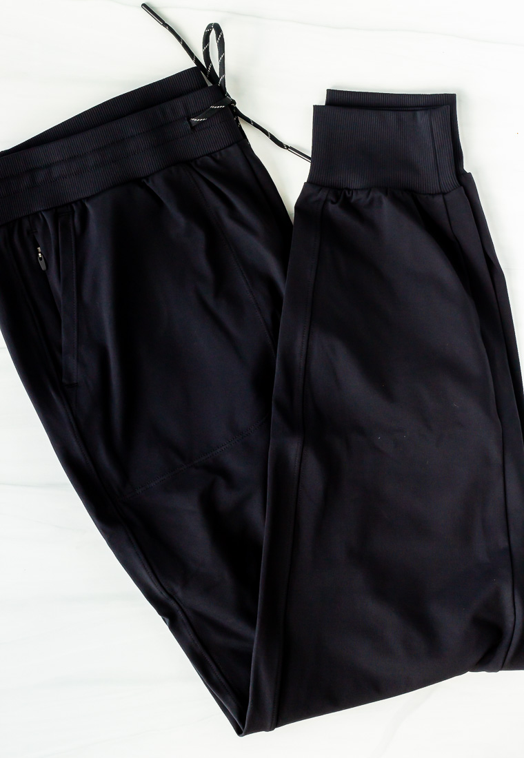 Black joggers folded on a white background