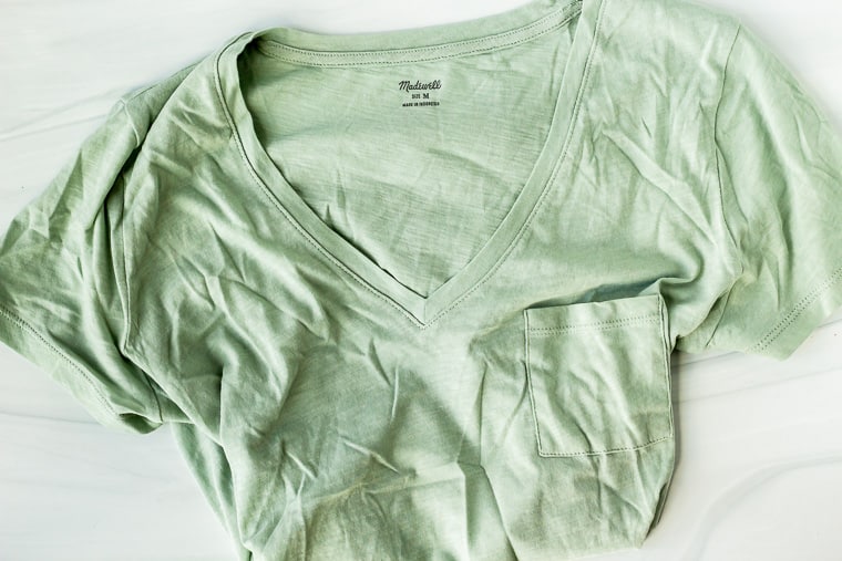 Madewell pocket v-neck in a light green color on a white background