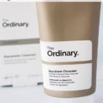 A tube of the ordinary squalane cleanser and the box with text overlay