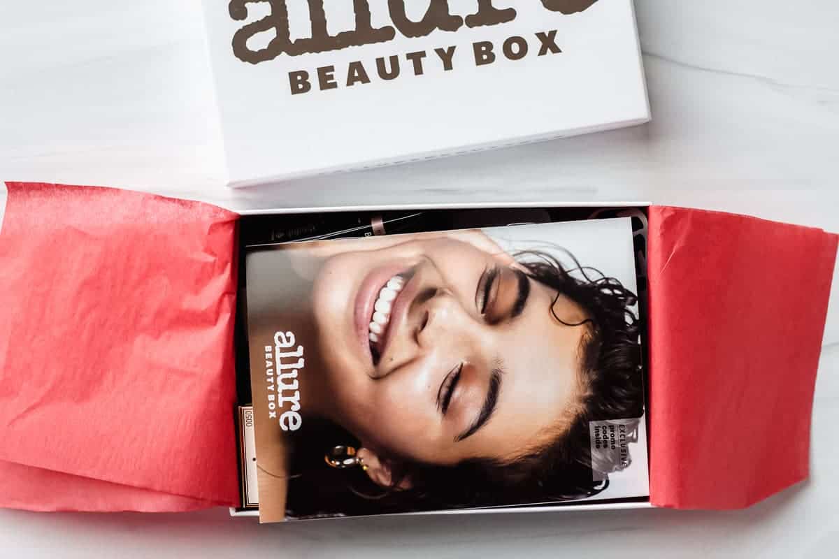 Opened August 2020 Allure Beauty Box on a white background