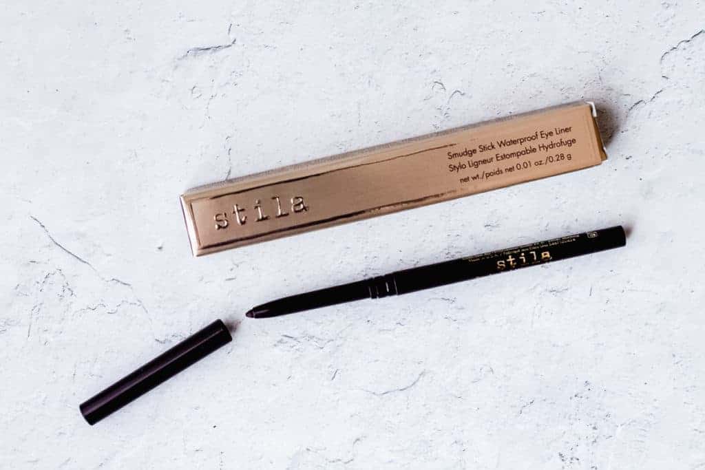 Stila Smudge Stick Waterproof Eye Liner in Damsel opened on a white background next to its packaging