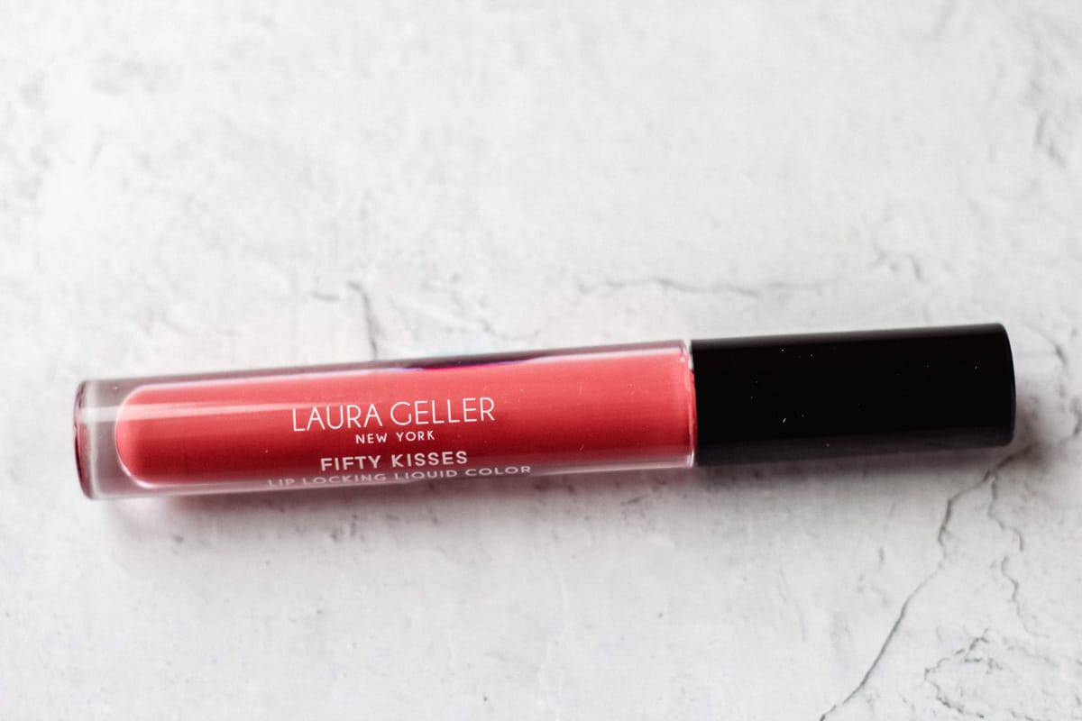 Laura Geller fifty kisses lip locking liquid in ruby romance on a white background