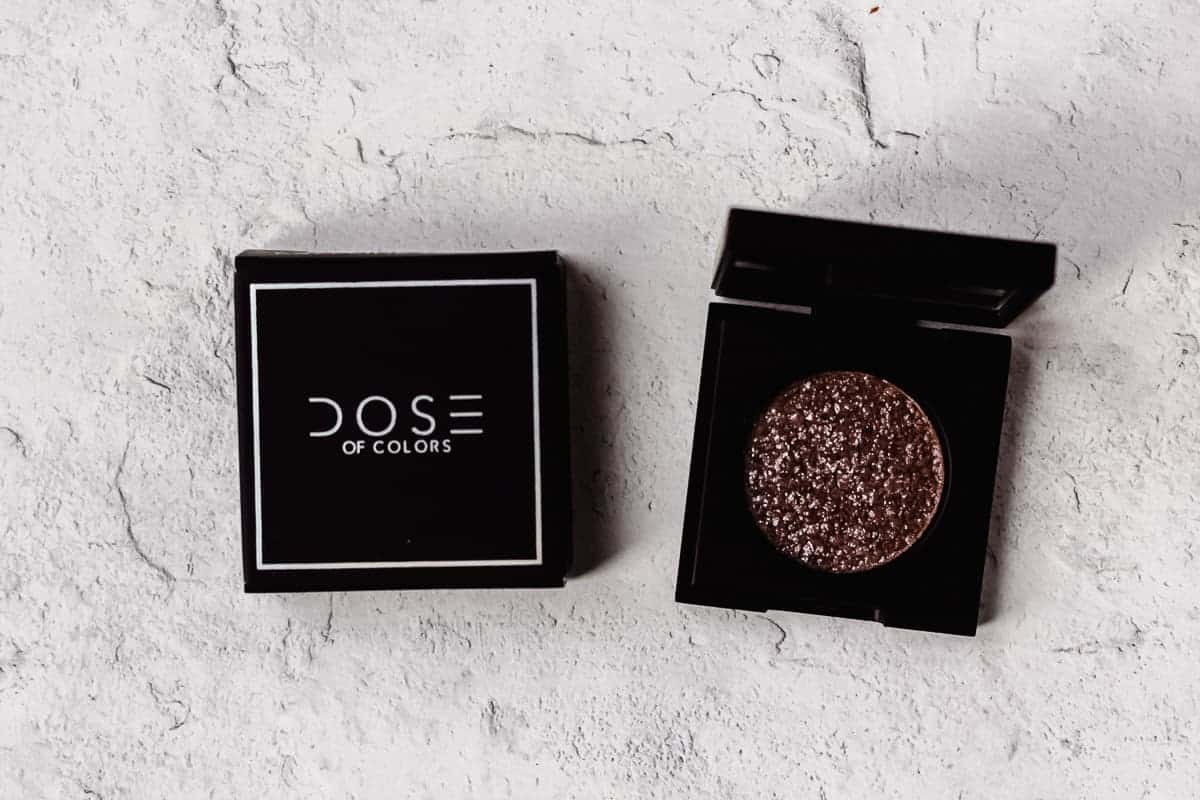 Dose of Colors Block Party Single Eyeshadow in Caffeine Queen next to it's box on a white background