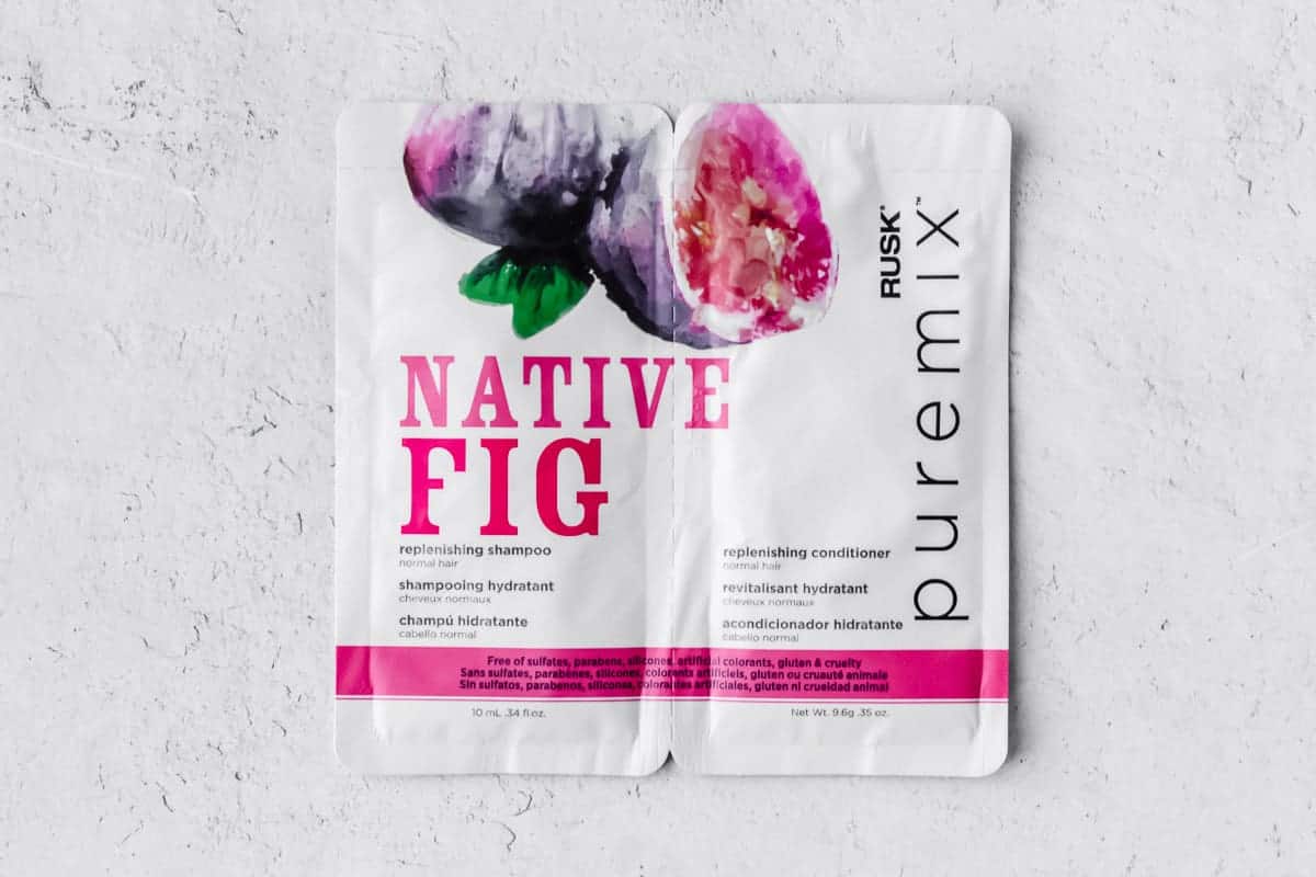 Rusk Native Fig Replenishing Shampoo and Conditioner packets on a white background