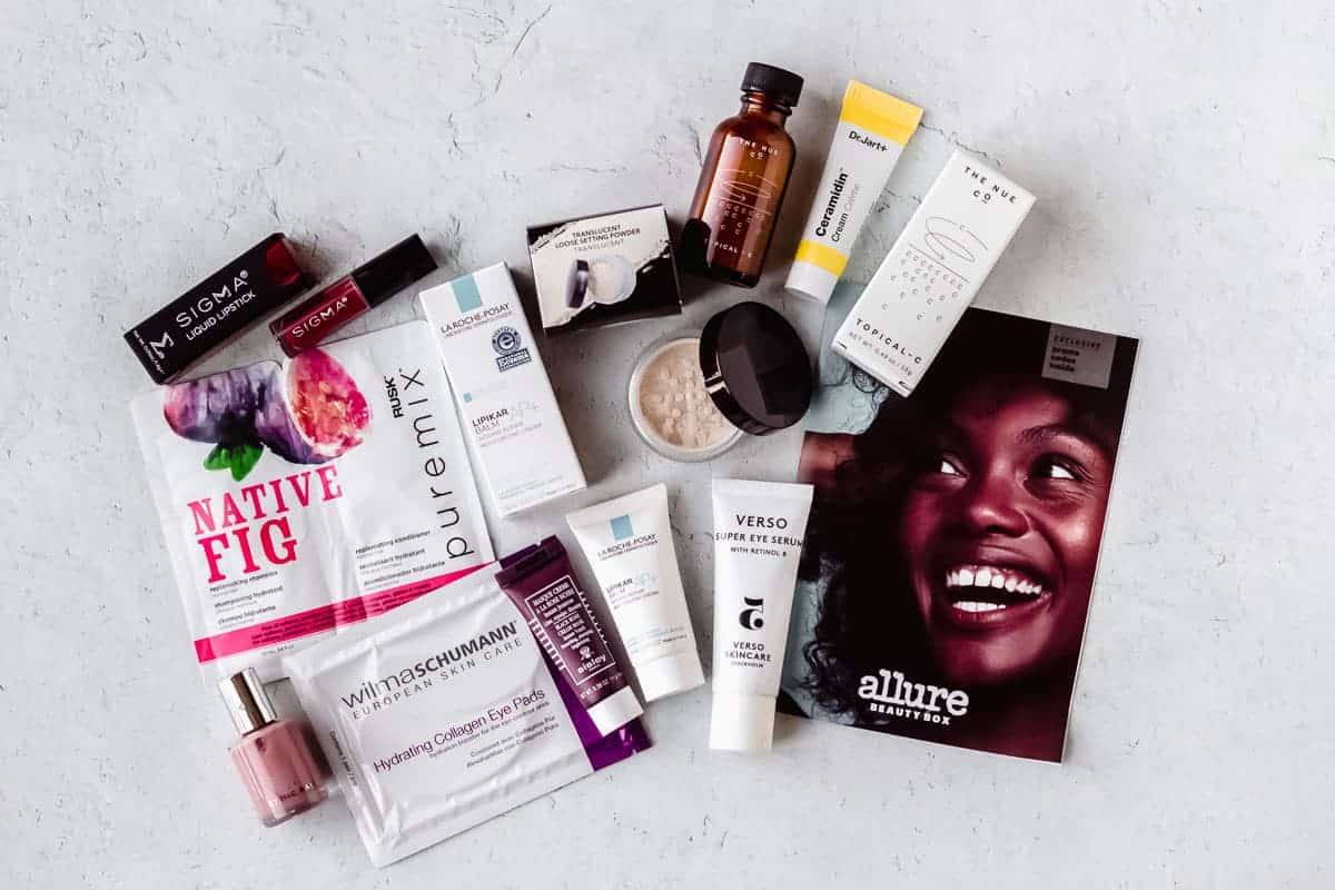 All of the beauty products and samples from the October 2020 Allure Beauty Box laid out on a white background