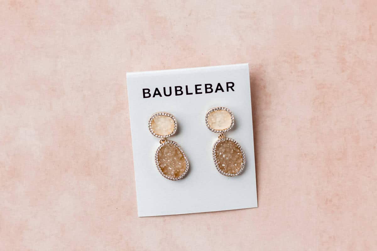 baublebar earrings on a peach background