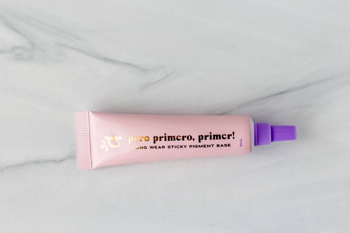 Alamar Cosmetics Pero Primero, Primer! Long Wear Sticky Pigment Base tube on a gray background