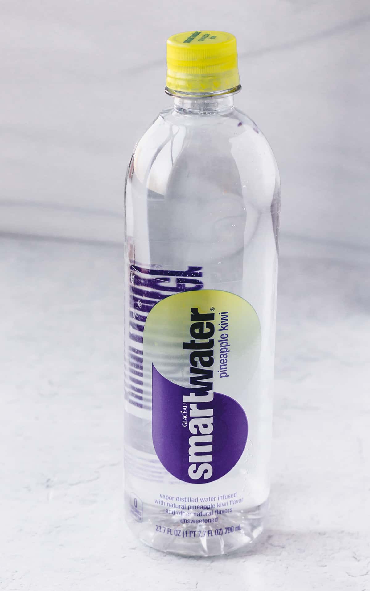 Smartwater Flavors bottle of water on a gray background