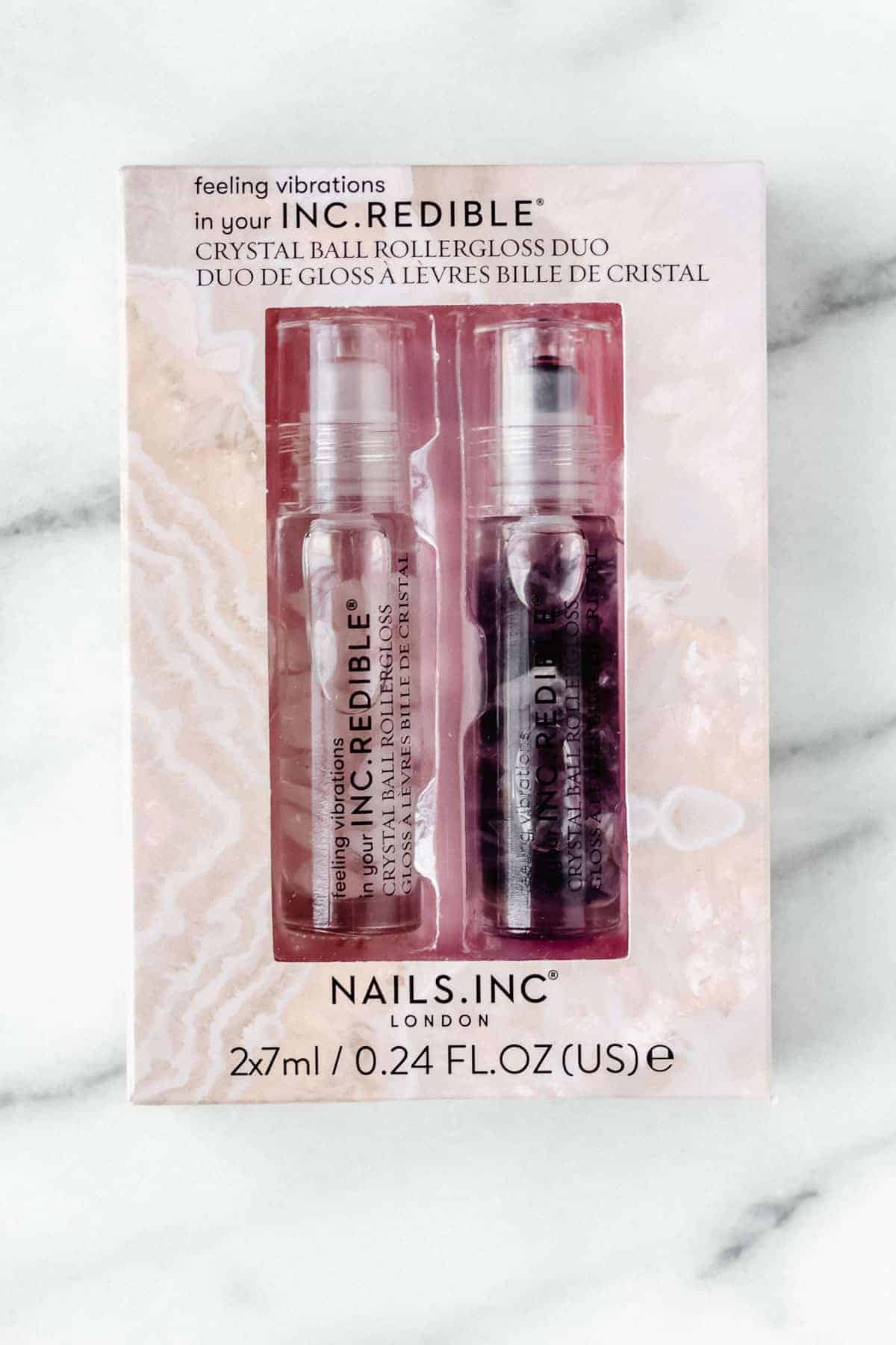 Nails Inc. Crystal Ball Rollergloss Duo in package on a marble backdrop