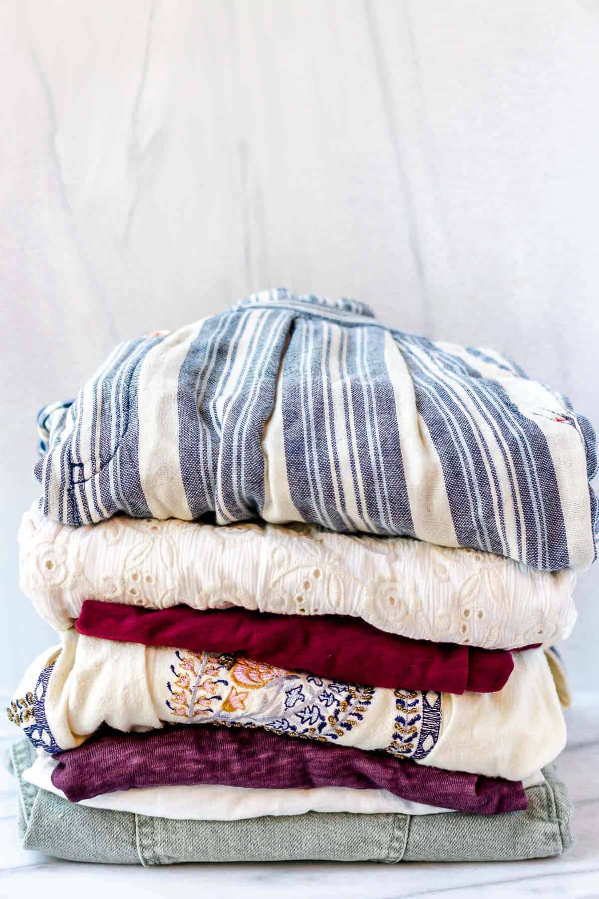 Folded clothes from summer 2021 anthropologie in a stack