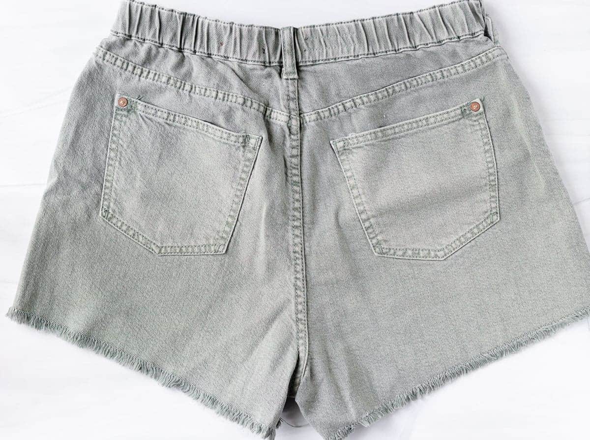 back of pilcro lara ultra-high rise frayed denim shorts