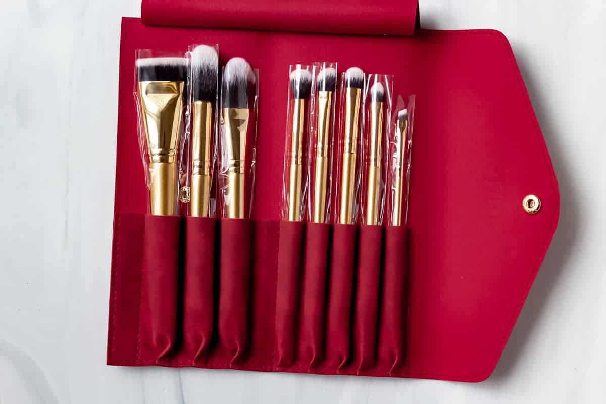 Luxie Glitter and Gold Brush Set in a red case on a white background