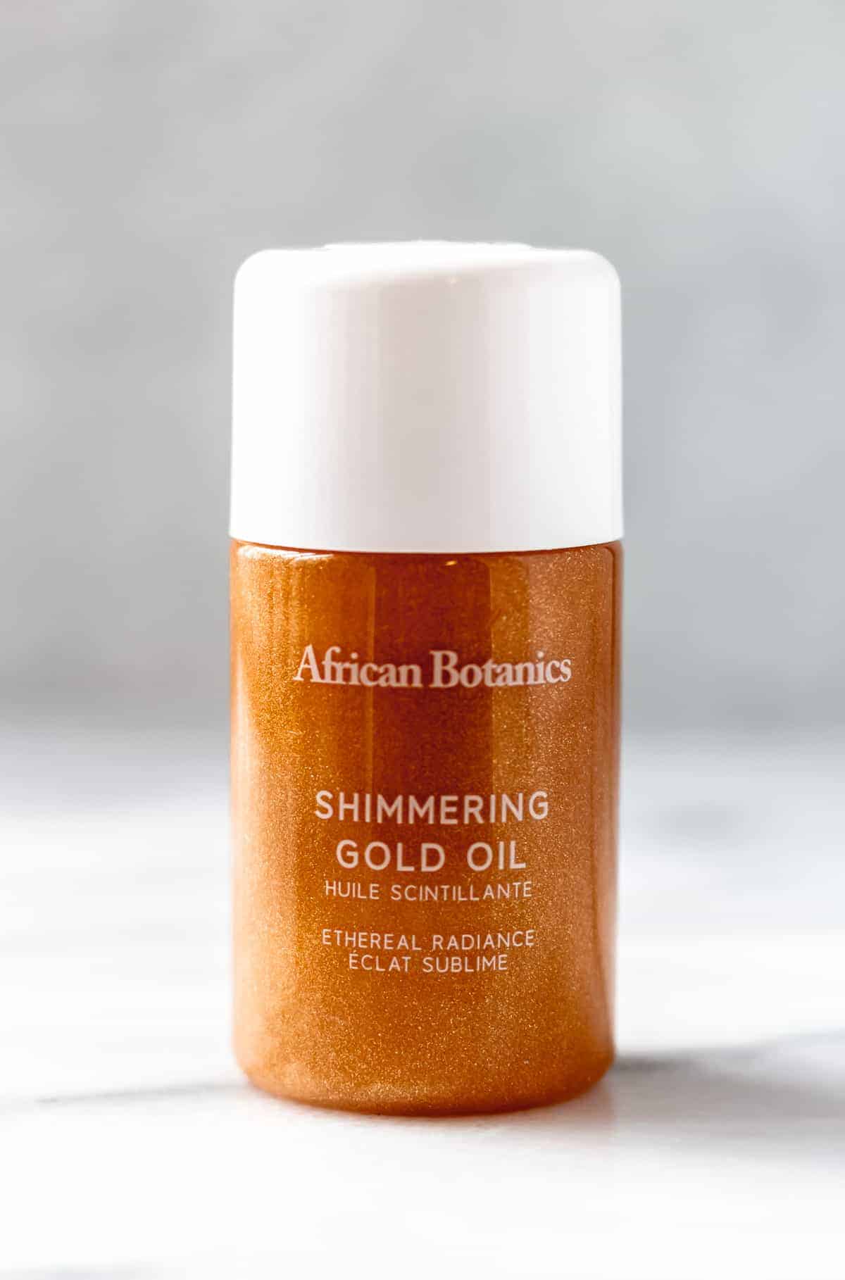 African Botanics Gold Shimmer Oil on a gray background