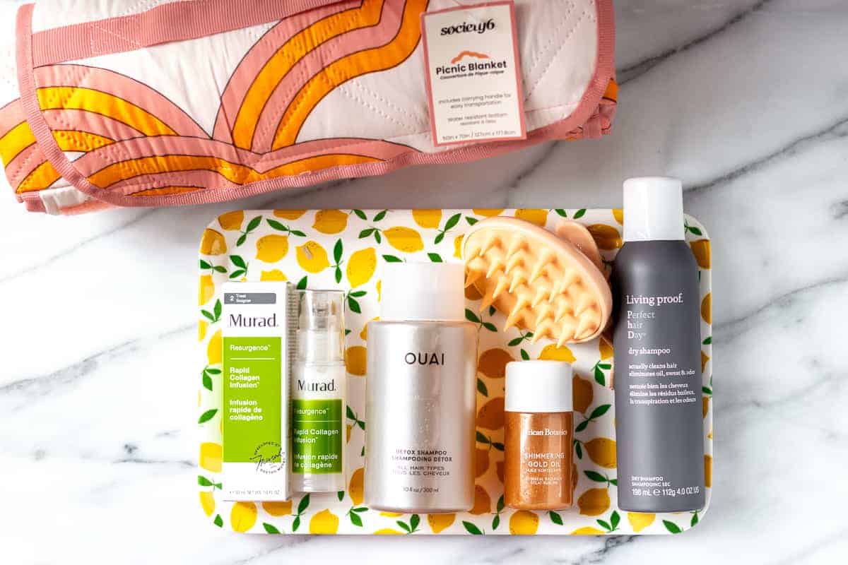 All of the items from my summer 2021 fabfitfun box laid out on a marble background