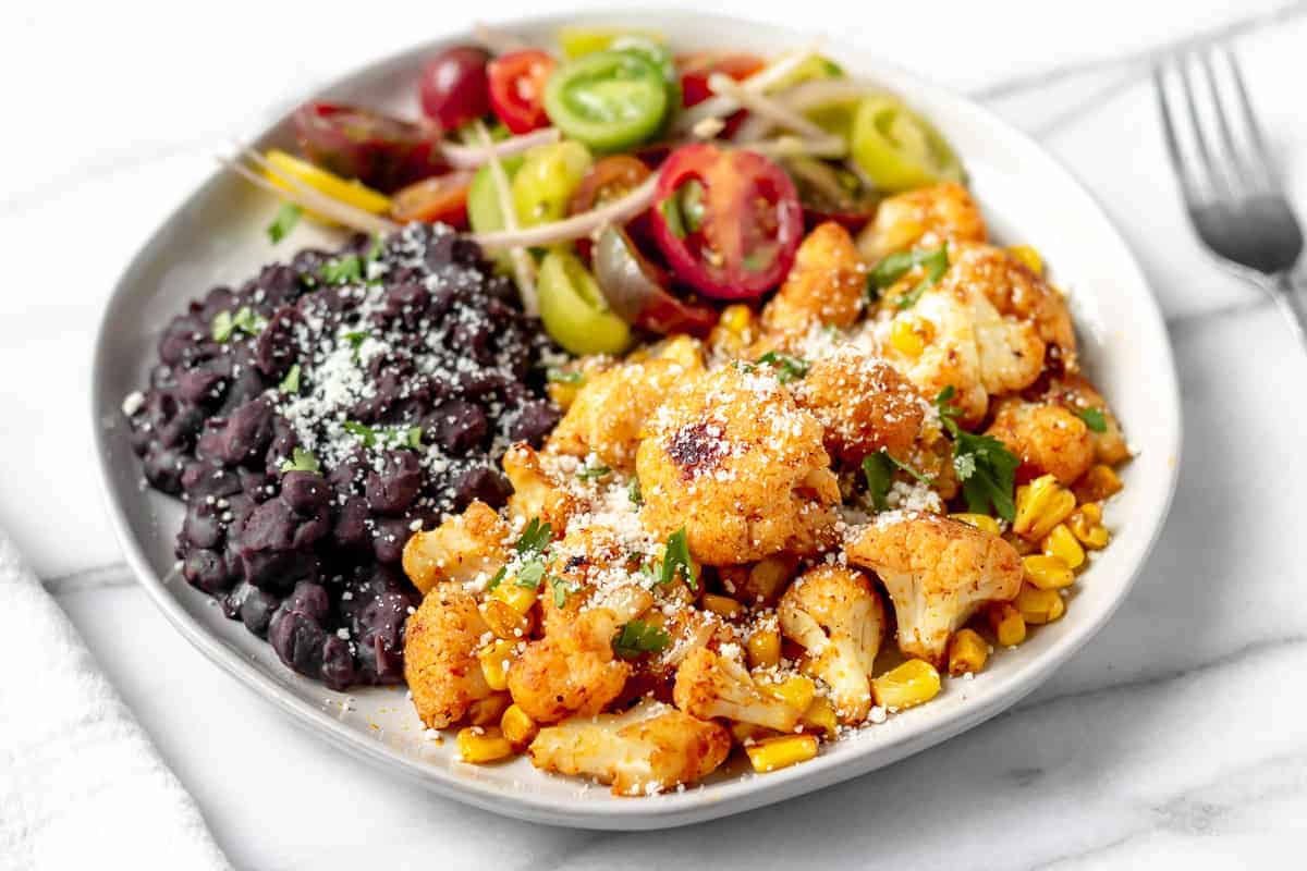 Mexican Spiced Cauliflower with Elote-Style Corn & Black Beans from Gobble on a white plate