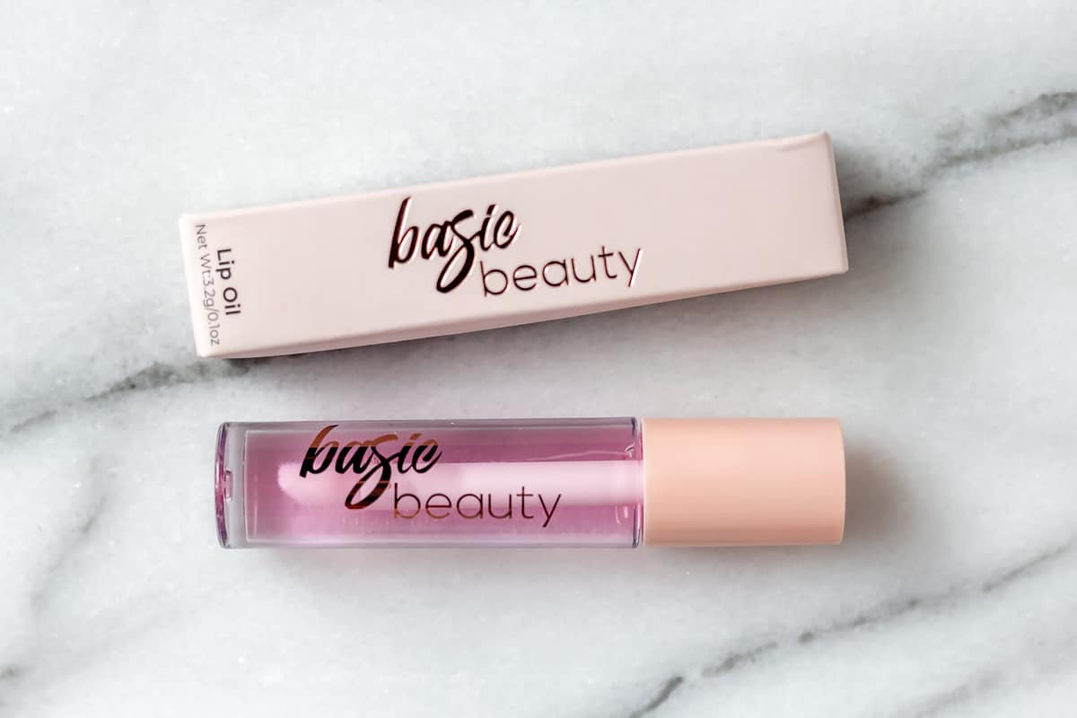 Basic Beauty Lip Oil in Summer on a marble background