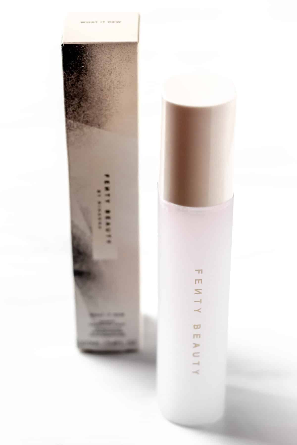 Fenty Beauty What-It-Dew Makeup Refreshing Spray bottle and box on a white background