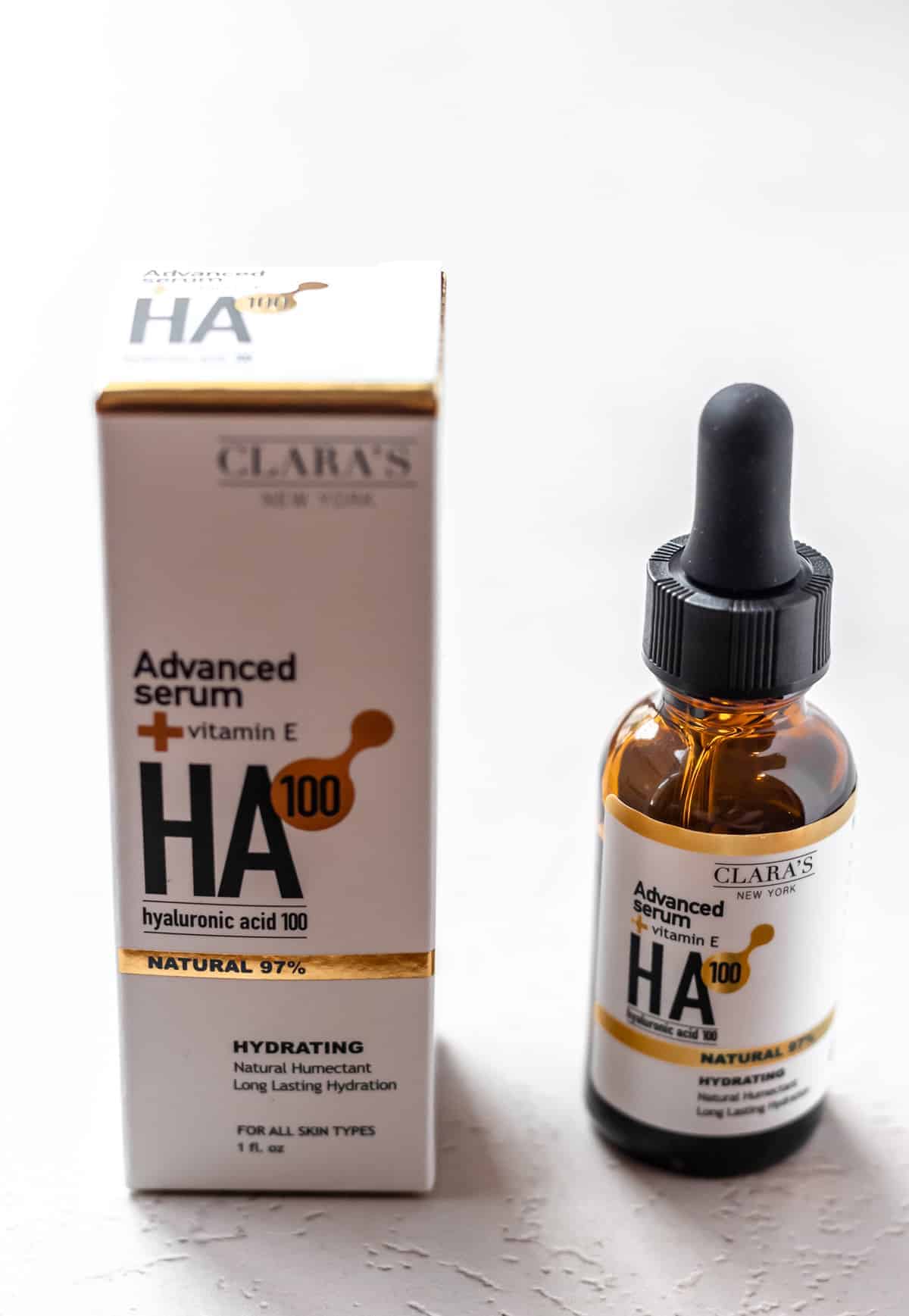 Clara's New York Hydrating Hyaluronic Acid 100 Facial Serum box and bottle on a light background