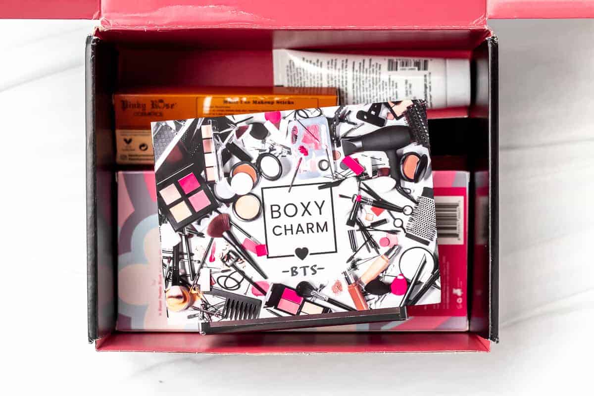 An opened September 2021 Boxycharm box with the insert card on top of the items inside.
