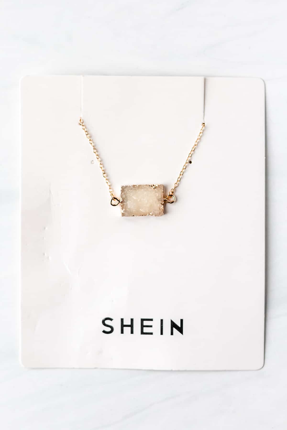 Geometric Charm Necklace in rectangle white.