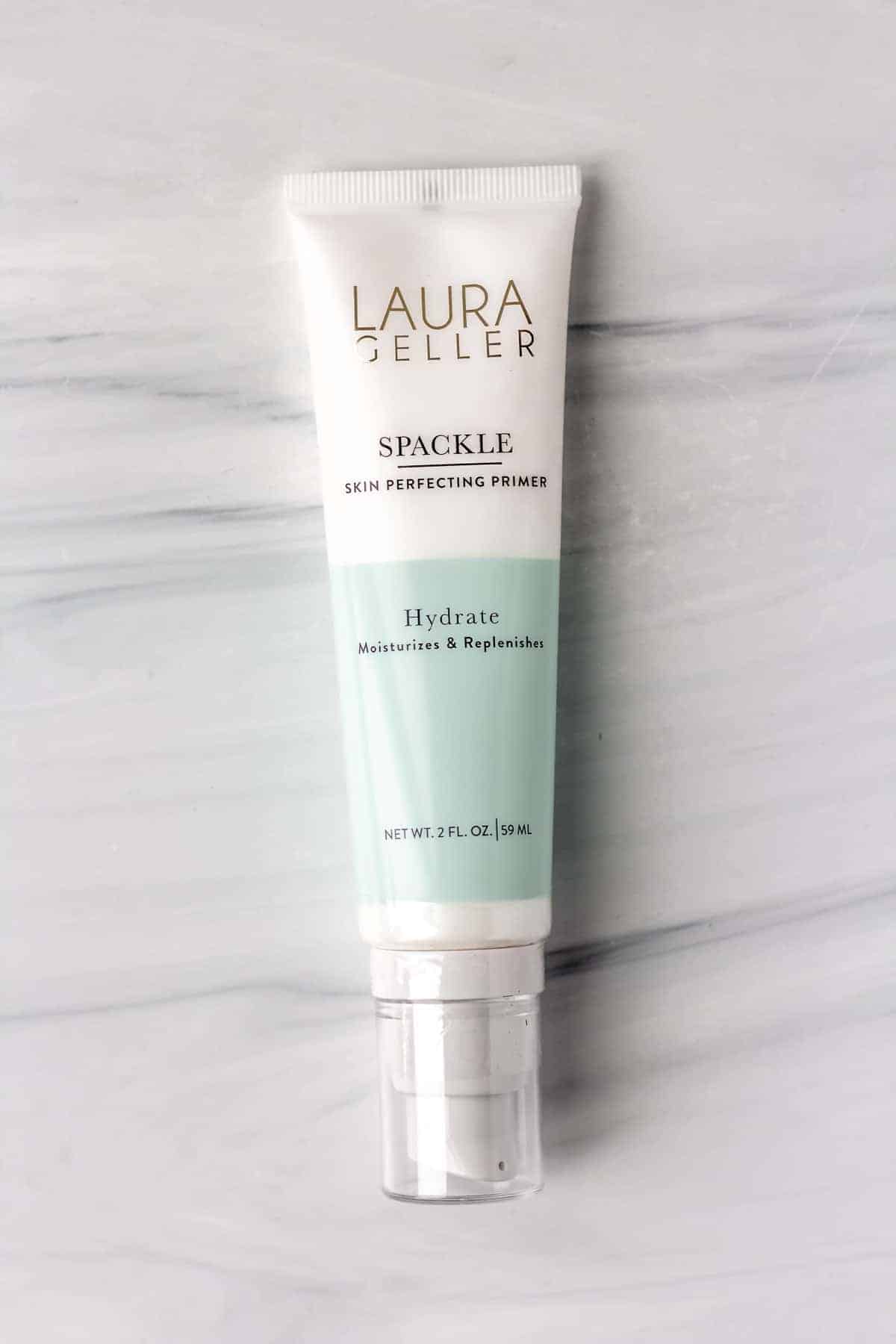 Laura Geller Spackle Skin Perfecting Primer: Hydrate tube on a gray background.