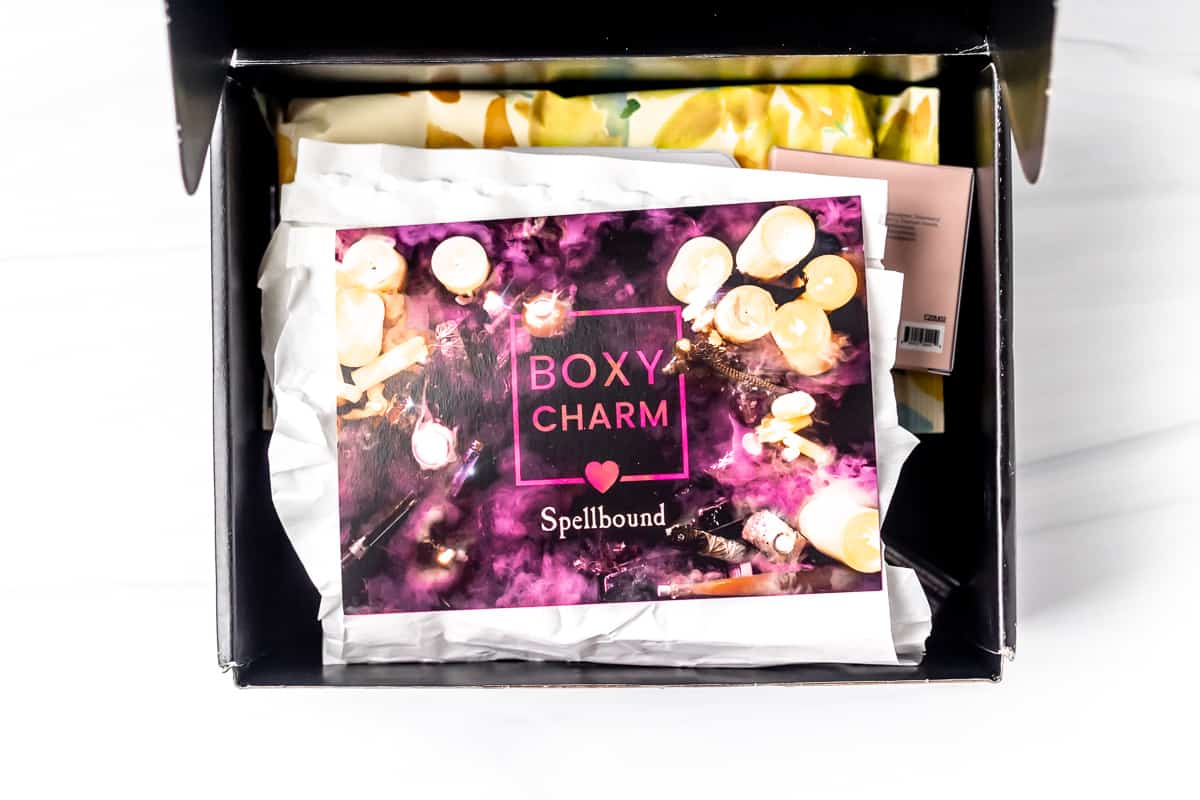 Opened October 2021 Boxycharm box on a white background with the insert card on top.