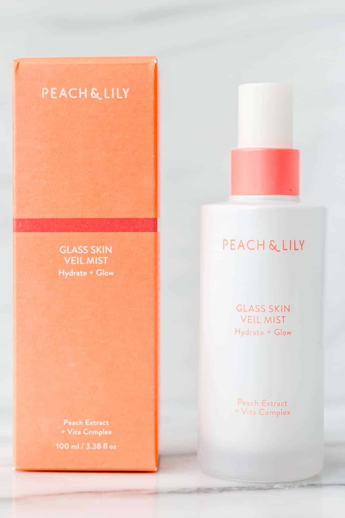 Peach & Lily Glass Skin Veil Mist bottle and box on a white background.