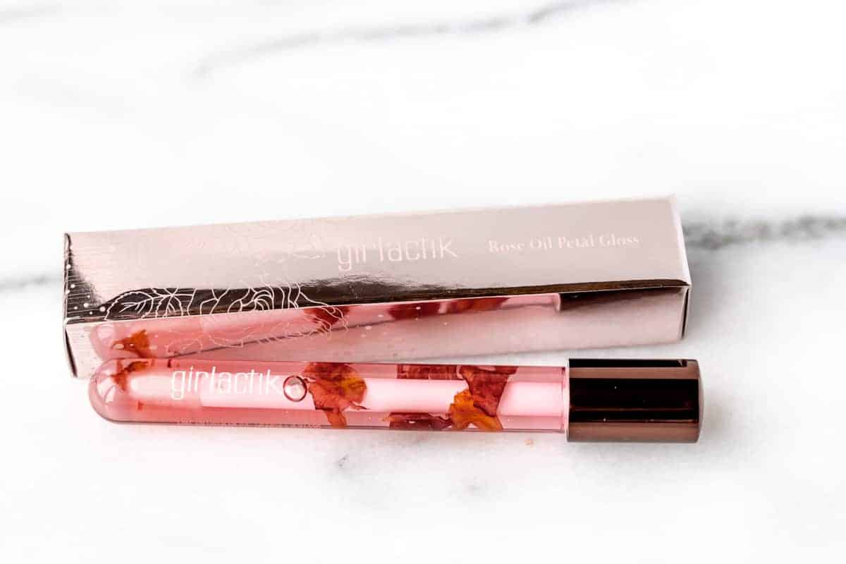 Girlactic Rose Oil Petal Gloss with the box on a white background.