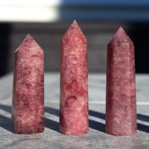 3 Red Aventurine Towers on a table.