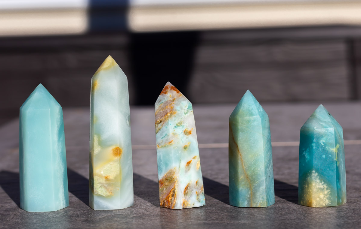 5 different Caribbean Calcite towers on a table outside.