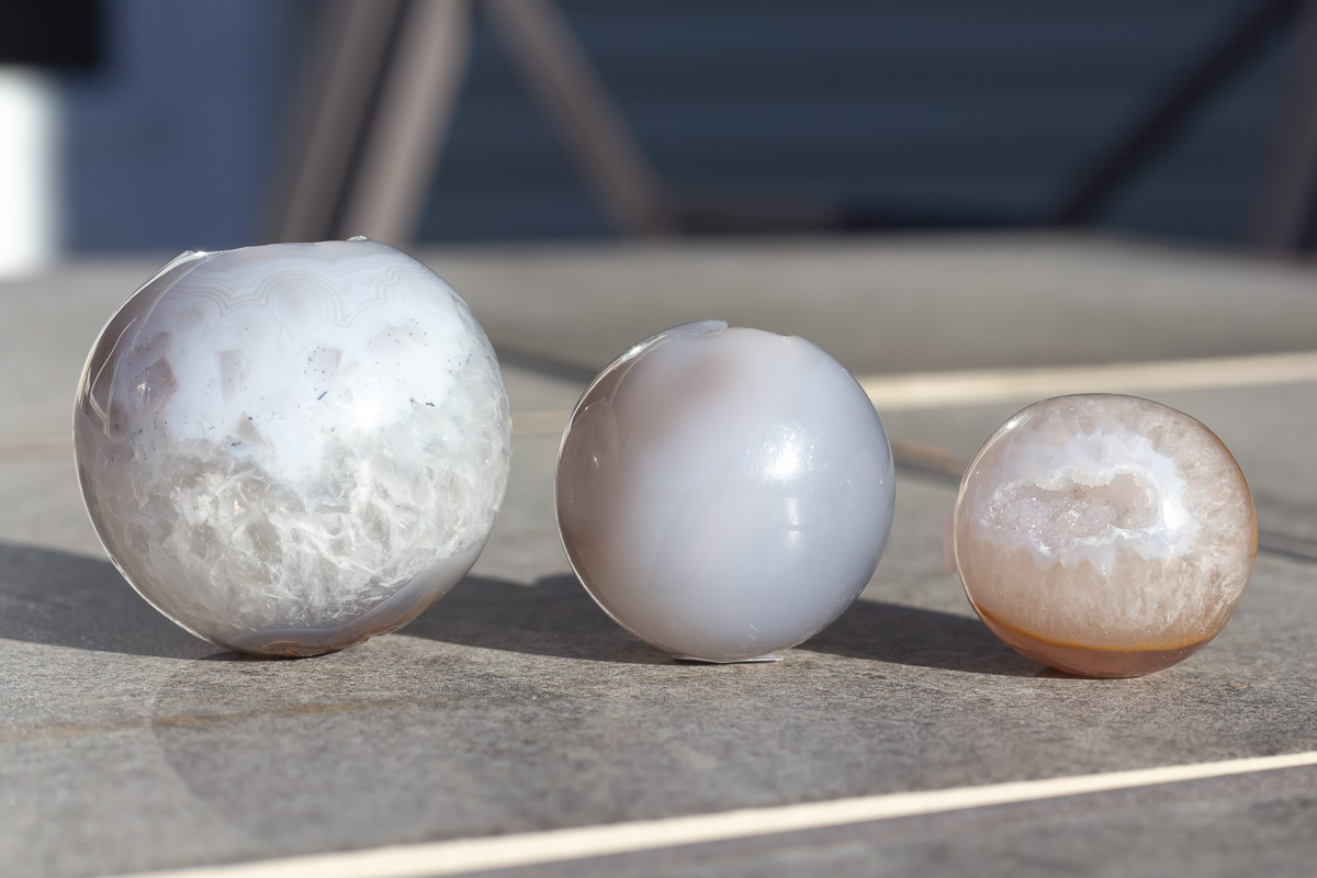 3 Agate spheres on a table.