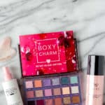 February 2022 Boxycharm premium items laid out on a marble background with text overlay.