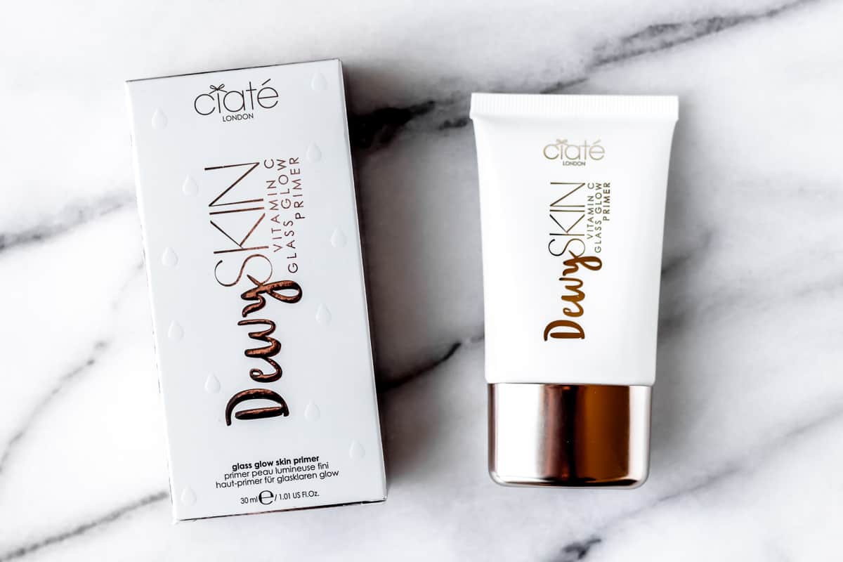 Ciate London Dewy Skin Vitamin C Glass Glow Primer tube and box on a marble background.