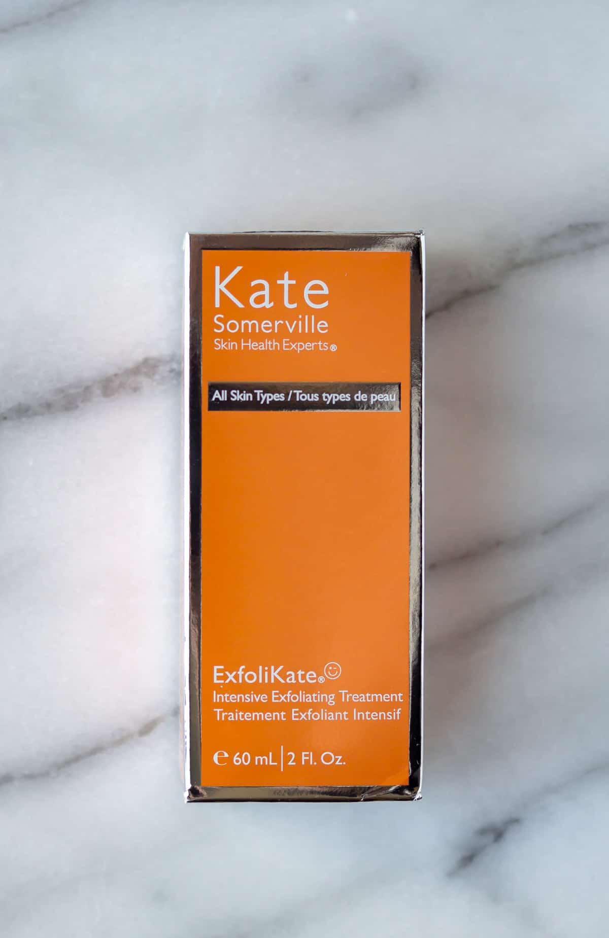 Kate Somerville Exfolikate box on a marble background.
