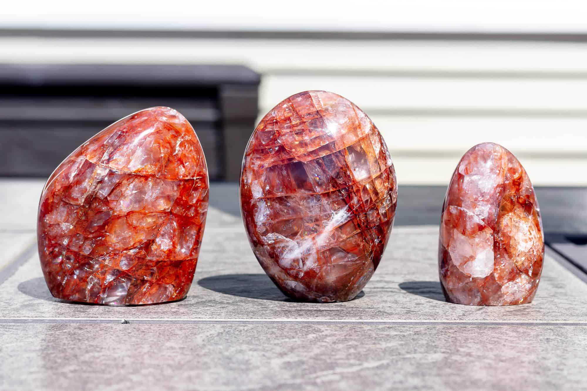 Three red hematoid quartz free forms.