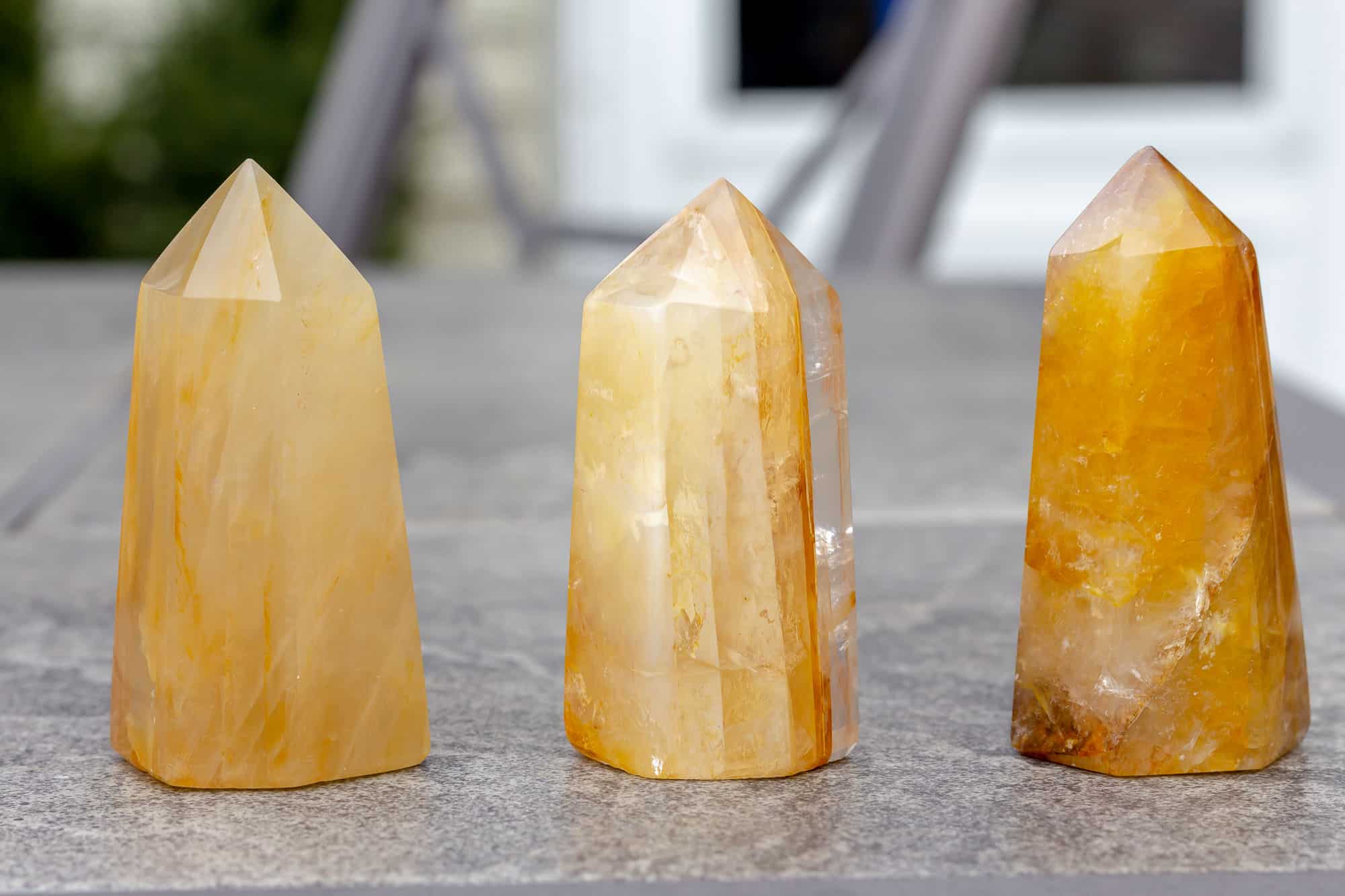 Three Golden Healer Towers on a gray table.