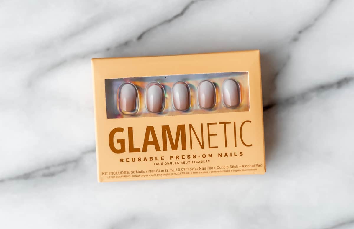A package of glamnetic press-on nails on a marble background.