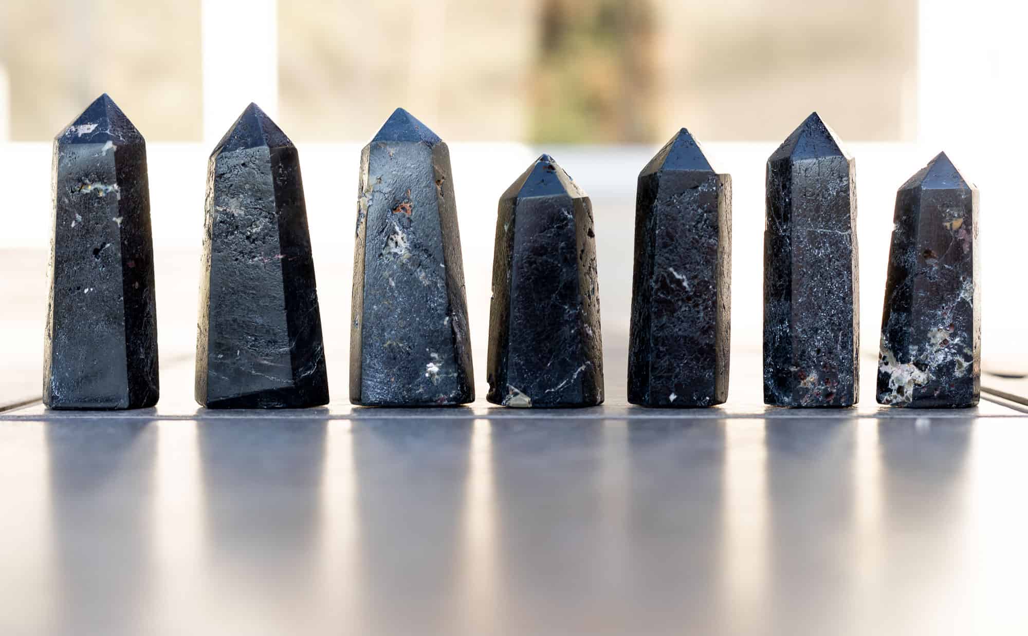 Black Tourmaline towers on a table.