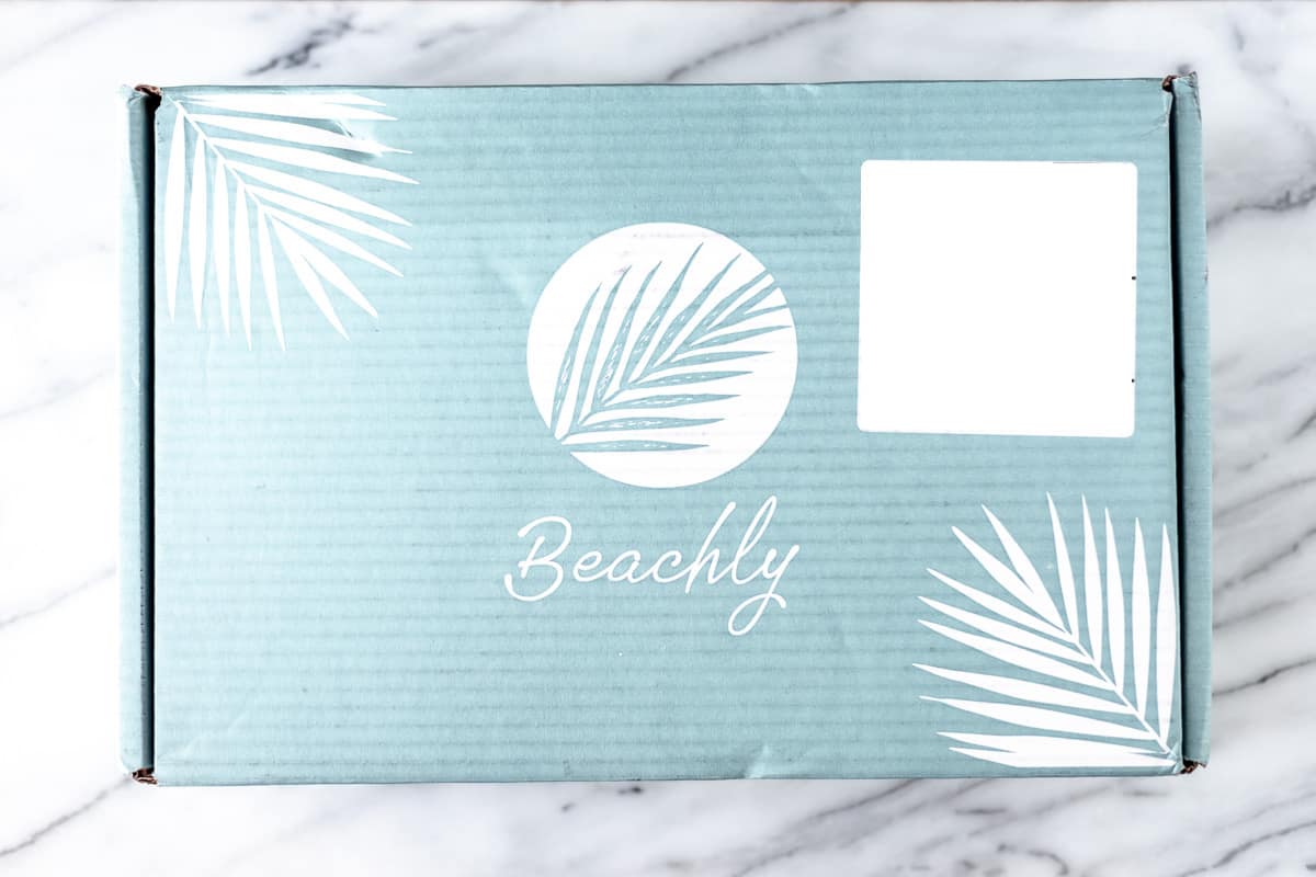 A summer 2023 Beachly box on a marble background.