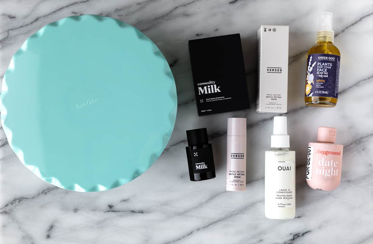 The cake stand and beauty products that came in my Winter 2023 Fabfitfun box on a marble background.