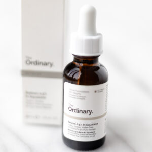 The Ordinary Retinol 0.5% bottle and box on a marble table.