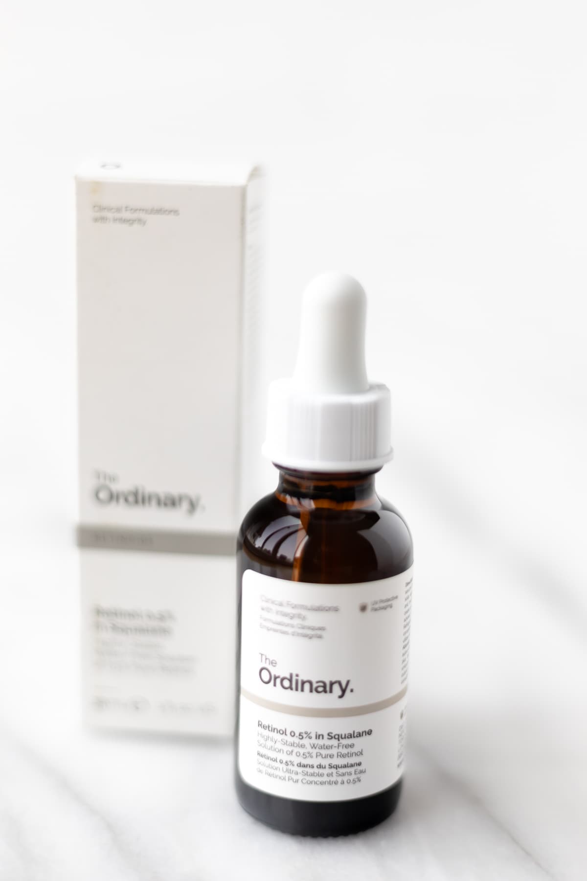 The Ordinary Retinol 0.5% bottle and box on a marble table.