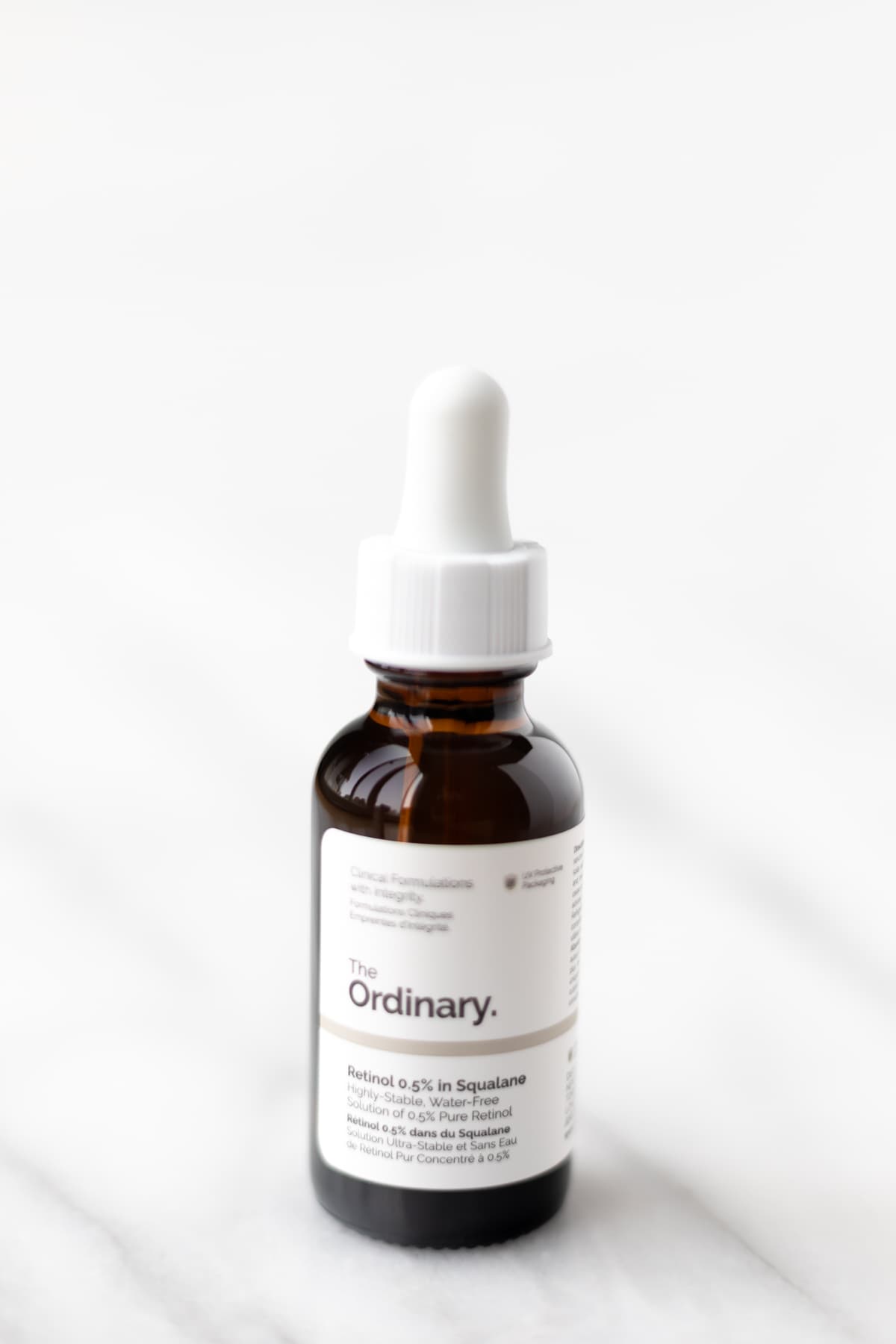 The Ordinary Retinol 0.5% bottle on a marble table.