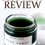 An opened jar of Herbivore Blue Tansy with text overlay.