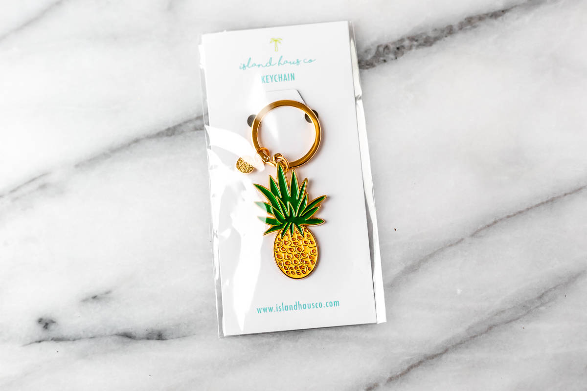 Pineapple Keychain By Island Haus Co on a marble background.
